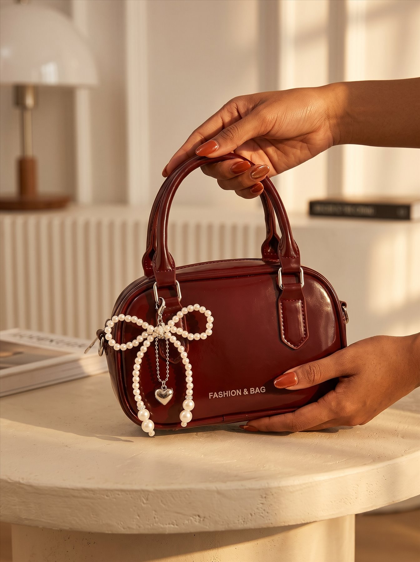Burgundy handbag styled with pearl jewellery