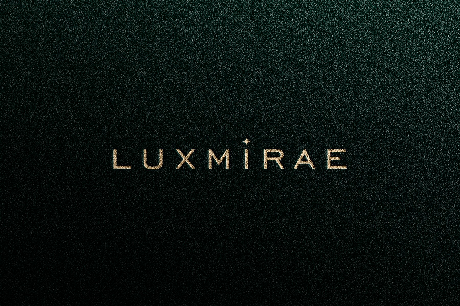 Luxmirae wordmark in gold on deep green leather
